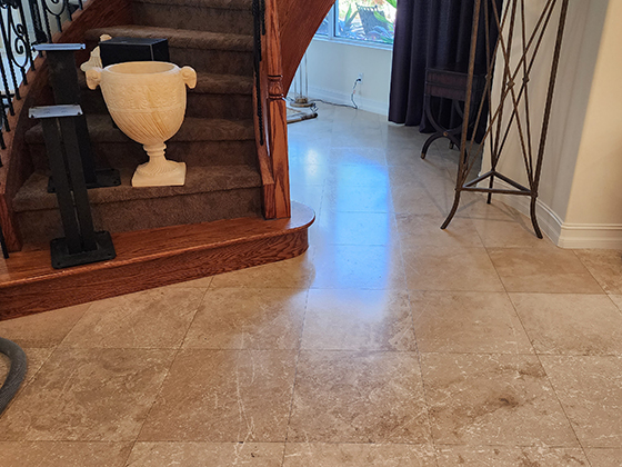 Dull damaged travertine floor before restoration.